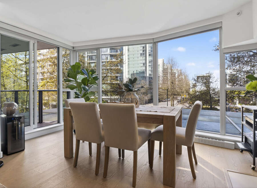 Experience urban living at its finest in this stunning condo! This property boasts a bright and airy dining area with floor-to-ceiling windows, offering breathtaking city views.