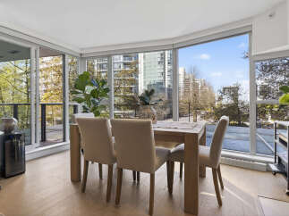 Experience urban living at its finest in this stunning condo! This property boasts a bright and airy dining area with floor-to-ceiling windows, offering breathtaking city views.