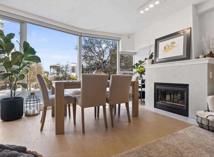 Experience luxury living in this stunning property, featuring a bright and airy dining area with expansive windows.