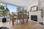 Experience luxury living in this stunning property, featuring a bright and airy dining area with expansive windows.