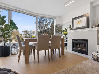 Experience luxury living in this stunning property, featuring a bright and airy dining area with expansive windows.