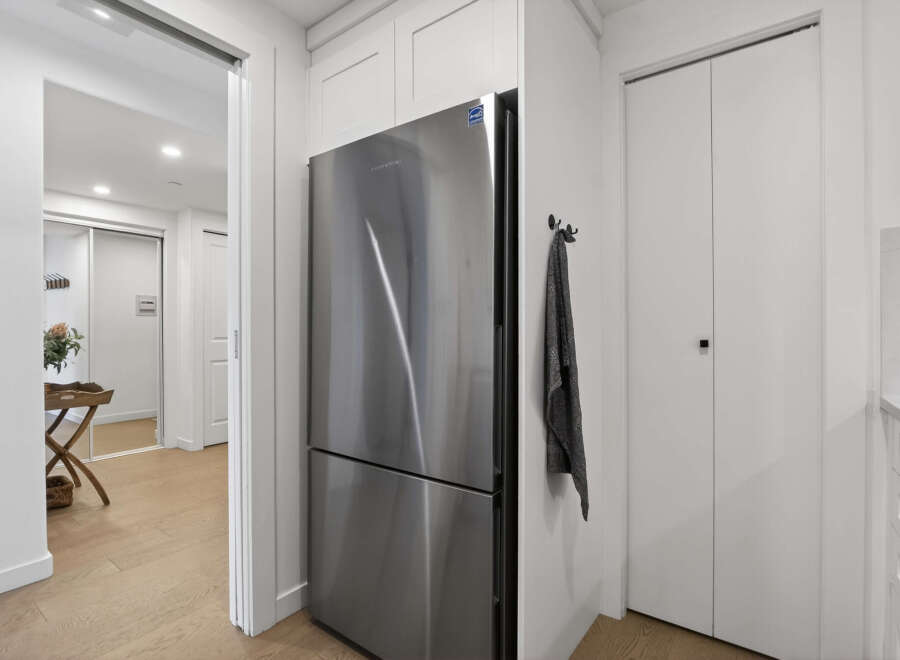 This modern kitchen features stainless steel appliances and sleek white cabinetry, creating a bright and inviting space.