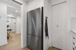 This modern kitchen features stainless steel appliances and sleek white cabinetry, creating a bright and inviting space.