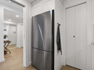 This modern kitchen features stainless steel appliances and sleek white cabinetry, creating a bright and inviting space.
