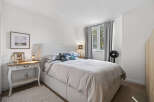 This inviting bedroom features a comfortable bed with soft bedding and a stylish headboard.