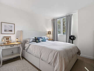 This inviting bedroom features a comfortable bed with soft bedding and a stylish headboard.