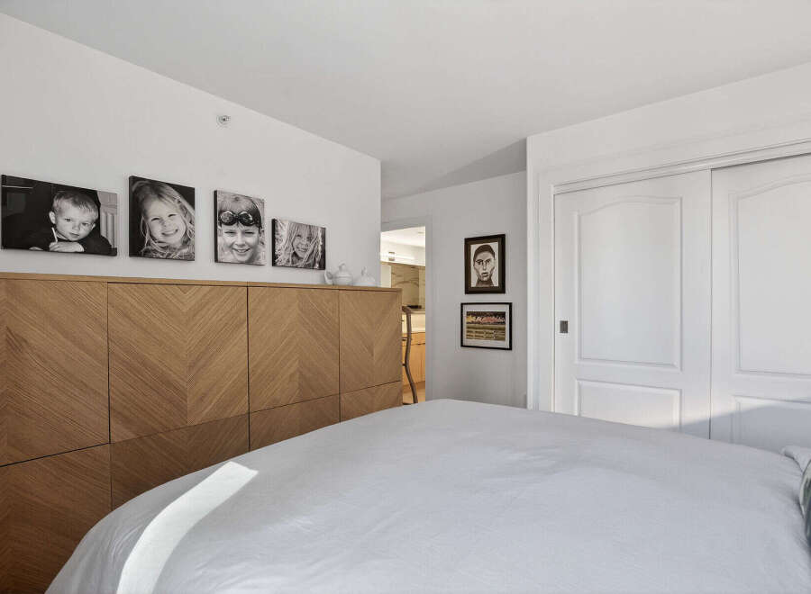 This stunning bedroom boasts a modern design with a focus on natural light and elegant finishes.