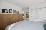 This stunning bedroom boasts a modern design with a focus on natural light and elegant finishes.