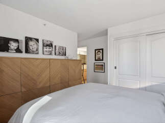 This stunning bedroom boasts a modern design with a focus on natural light and elegant finishes.