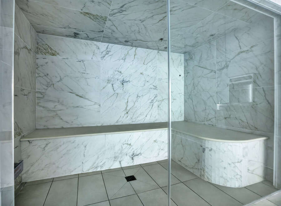 Step into luxury with this stunning marble-clad steam shower.
