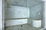 Step into luxury with this stunning marble-clad steam shower.