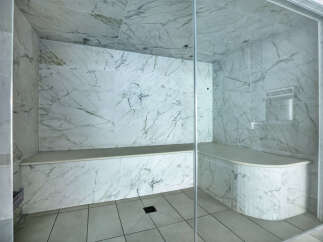 Step into luxury with this stunning marble-clad steam shower.