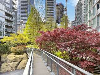 Discover urban living at its finest with this stunning property, featuring a serene bridge surrounded by vibrant red and yellow trees.
