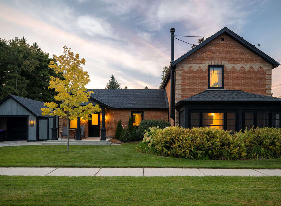 This stunning property showcases a beautifully renovated brick home with a charming garage.