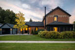 This stunning property showcases a beautifully renovated brick home with a charming garage.