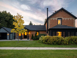 This stunning property showcases a beautifully renovated brick home with a charming garage.