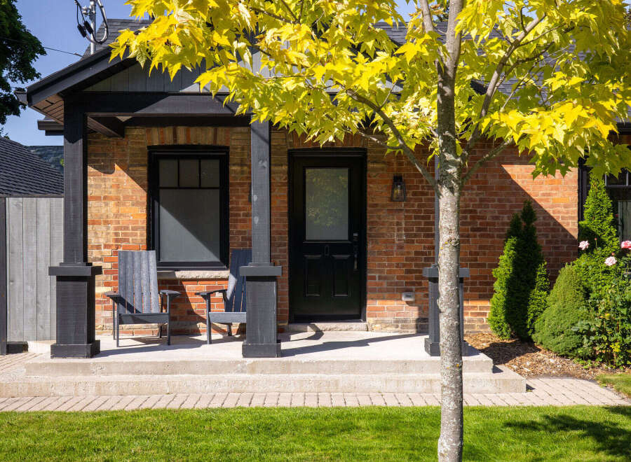 Charming brick home with a welcoming front porch.