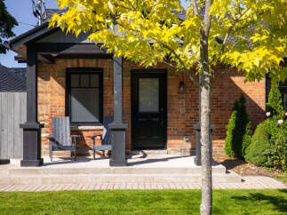 Charming brick home with a welcoming front porch.
