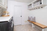 This stunning laundry room boasts a modern design with a touch of rustic charm.