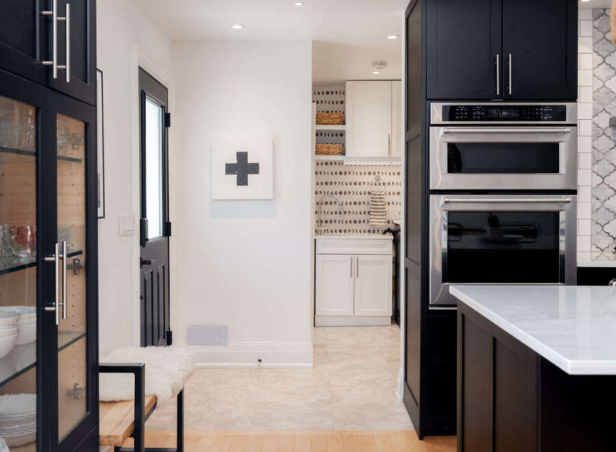 This stunning kitchen boasts modern design with sleek black cabinetry and stainless steel appliances.