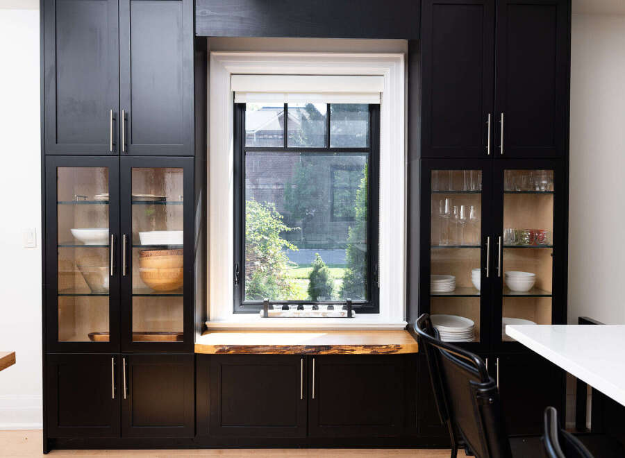 This stunning kitchen boasts sleek black cabinetry, offering ample storage and a modern aesthetic.