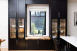 This stunning kitchen boasts sleek black cabinetry, offering ample storage and a modern aesthetic.