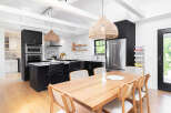 This stunning kitchen and dining area boasts a modern design with a touch of warmth.