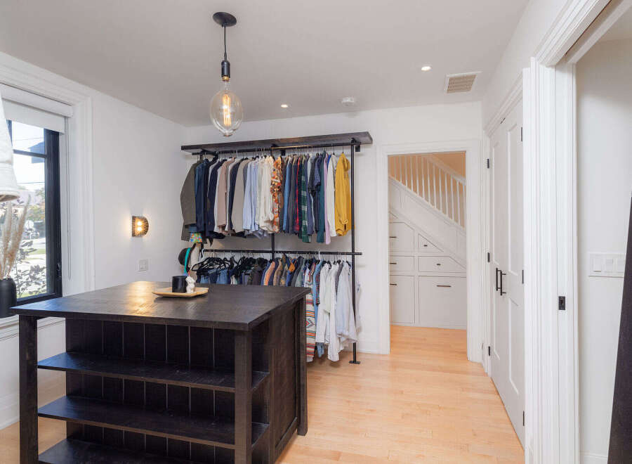 Step into luxury with this stunning walk-in closet, designed for both style and functionality.