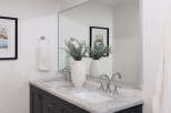 This stunning bathroom features a modern design with a marble countertop and dual sinks, offering both style and functionality.