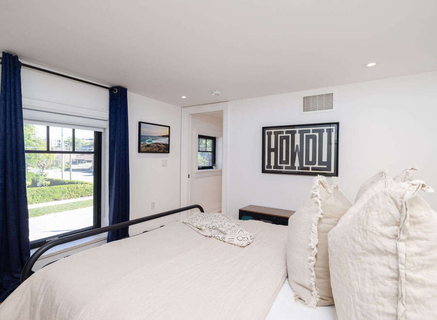 Step into this inviting bedroom, featuring a comfortable bed and stylish decor.