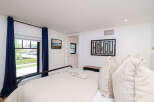 Step into this inviting bedroom, featuring a comfortable bed and stylish decor.