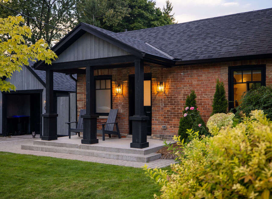 This charming brick home boasts a welcoming front porch, perfect for enjoying the outdoors.