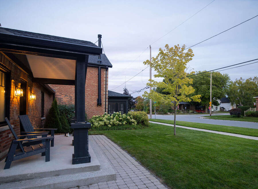 This charming brick home boasts a welcoming front porch, perfect for enjoying the neighborhood.