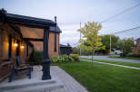 This charming brick home boasts a welcoming front porch, perfect for enjoying the neighborhood.