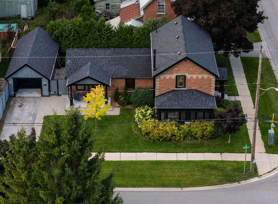 This stunning property boasts a charming brick exterior and a well-maintained lawn, perfect for curb appeal.