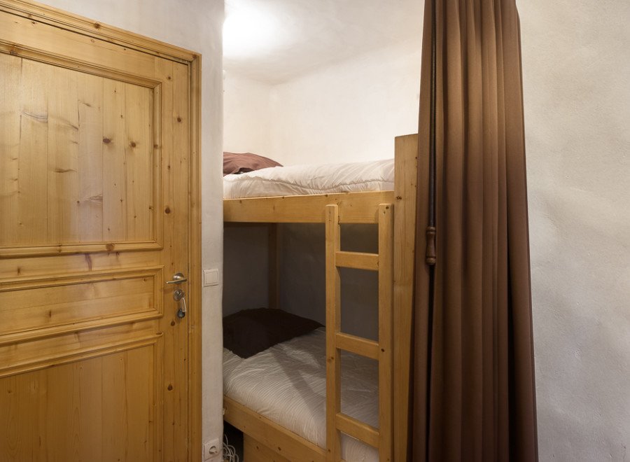 Cozy bunk beds tucked away in a charming room, perfect for a comfortable stay.