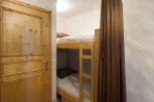 Cozy bunk beds tucked away in a charming room, perfect for a comfortable stay.