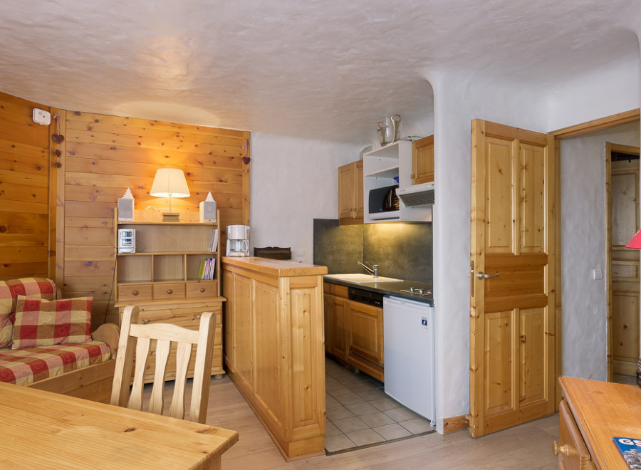 Cozy chalet apartment with a fully equipped kitchenette, perfect for a couple's getaway.
