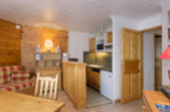 Cozy chalet apartment with a fully equipped kitchenette, perfect for a couple's getaway.