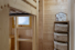 Cozy wooden bunk bed in a charming chalet-style room.