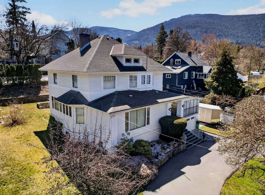 This stunning white house boasts a classic design with a charming facade and a well-maintained exterior.