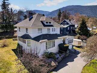 This stunning white house boasts a classic design with a charming facade and a well-maintained exterior.