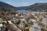 Discover a charming home nestled in a picturesque town, offering stunning views of the surrounding mountains and a serene lake.