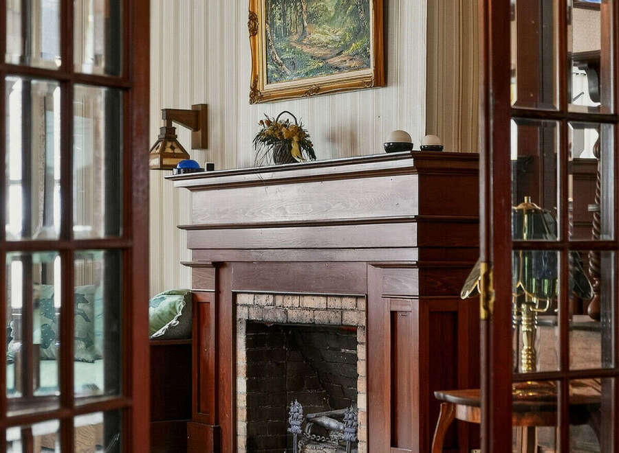 Step into a world of timeless elegance with this stunning property, featuring a beautifully crafted fireplace as its centerpiece.