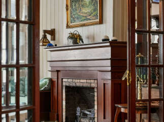 Step into a world of timeless elegance with this stunning property, featuring a beautifully crafted fireplace as its centerpiece.