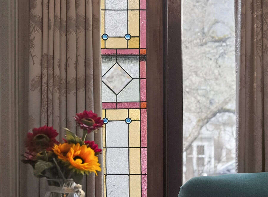 This stunning property boasts a beautiful stained glass window, adding a touch of elegance and charm to the space.