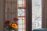 This stunning property boasts a beautiful stained glass window, adding a touch of elegance and charm to the space.