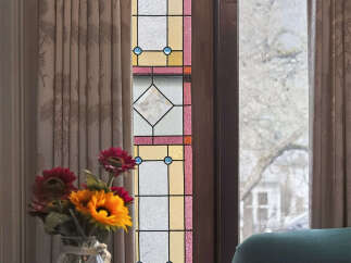 This stunning property boasts a beautiful stained glass window, adding a touch of elegance and charm to the space.
