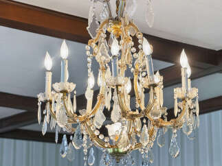 Elegant chandelier illuminates a room, adding a touch of luxury and sophistication.