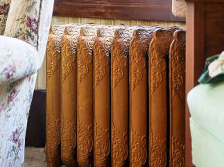This image showcases a beautifully preserved antique radiator, a charming detail often found in historic homes.